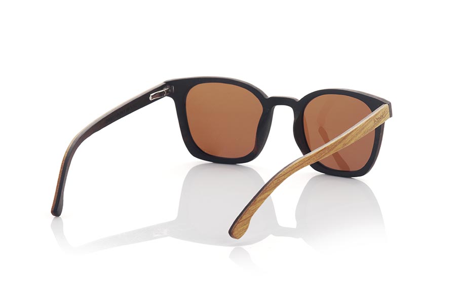 Wood eyewear of Walnut DAIVI. DAIVI wooden sunglasses are a variation of our GUSTAV model. In this model, the frame spectacularly combines walnut and oak wood in different reliefs, while the temples are made of oak on the outside and walnut on the inside. This unisex model combines the rounded relief with a squarer frame to give an elegant and sophisticated appearance. The glasses are available in two solid lens colors, brown and grey. With the DAIVI, you will have a fresh and modern look while enjoying the unique quality and style that only wooden glasses can offer. Front Measurement: 141X47mm Caliber:48 for Wholesale & Retail | Root Sunglasses® 